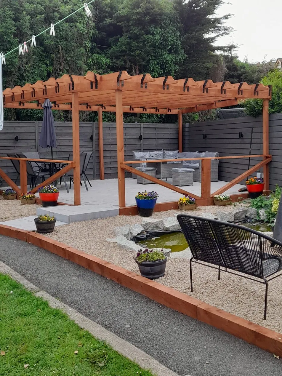 Bespoke garden design with patio, decorative gravel and pond