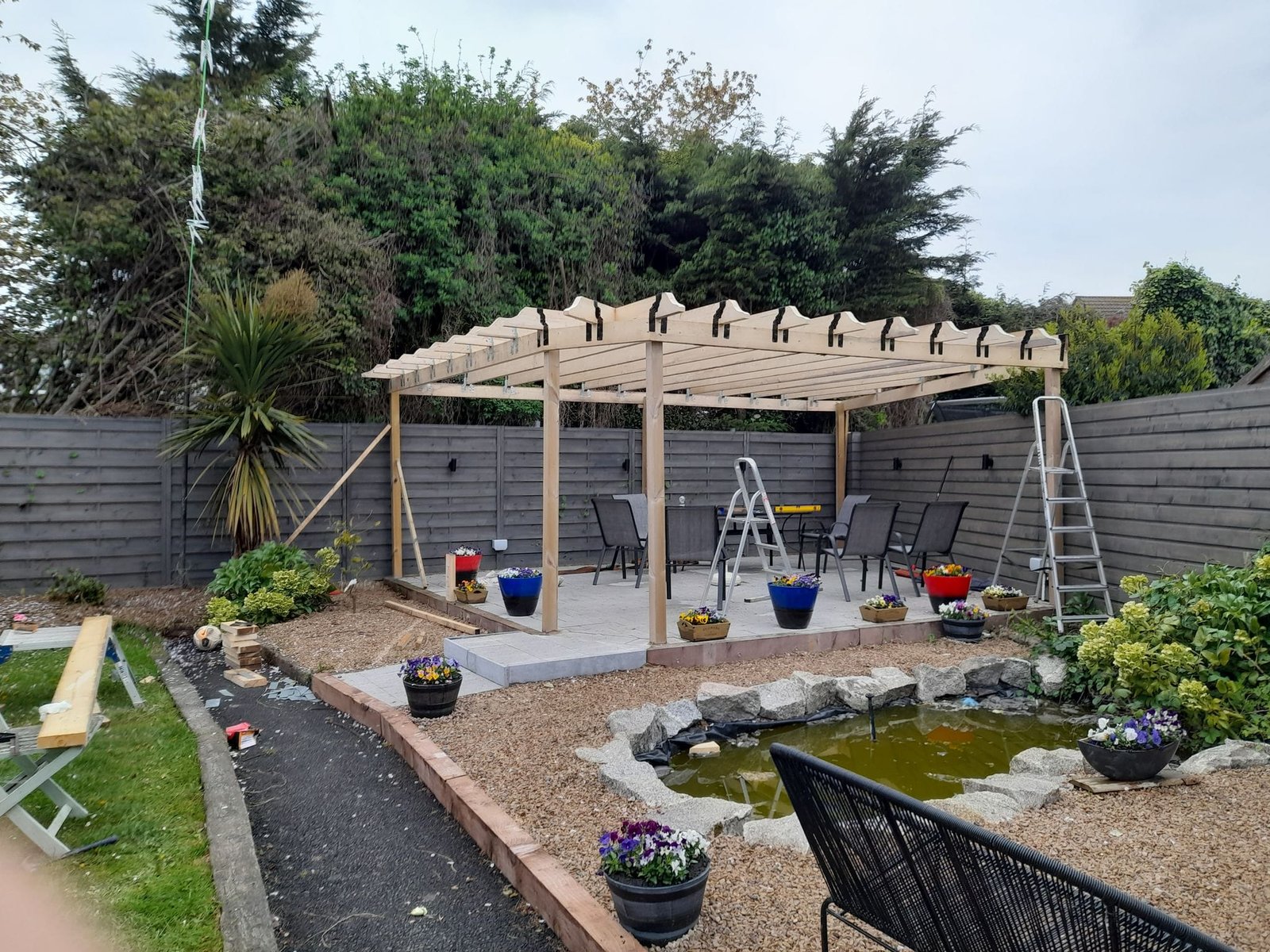 Garden transformation in progress showing pergola construction, Dublin