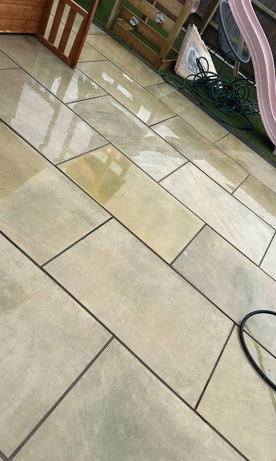 Natural stone patio surface being washed during Reflect exterior maintenance work