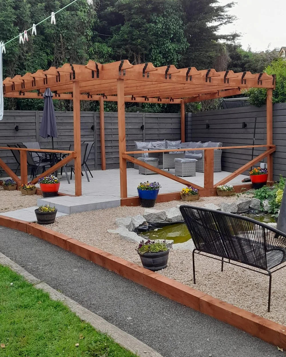 Finished freestanding timber pergola with seating area and pond in a Dublin garden by Reflect General Maintenance