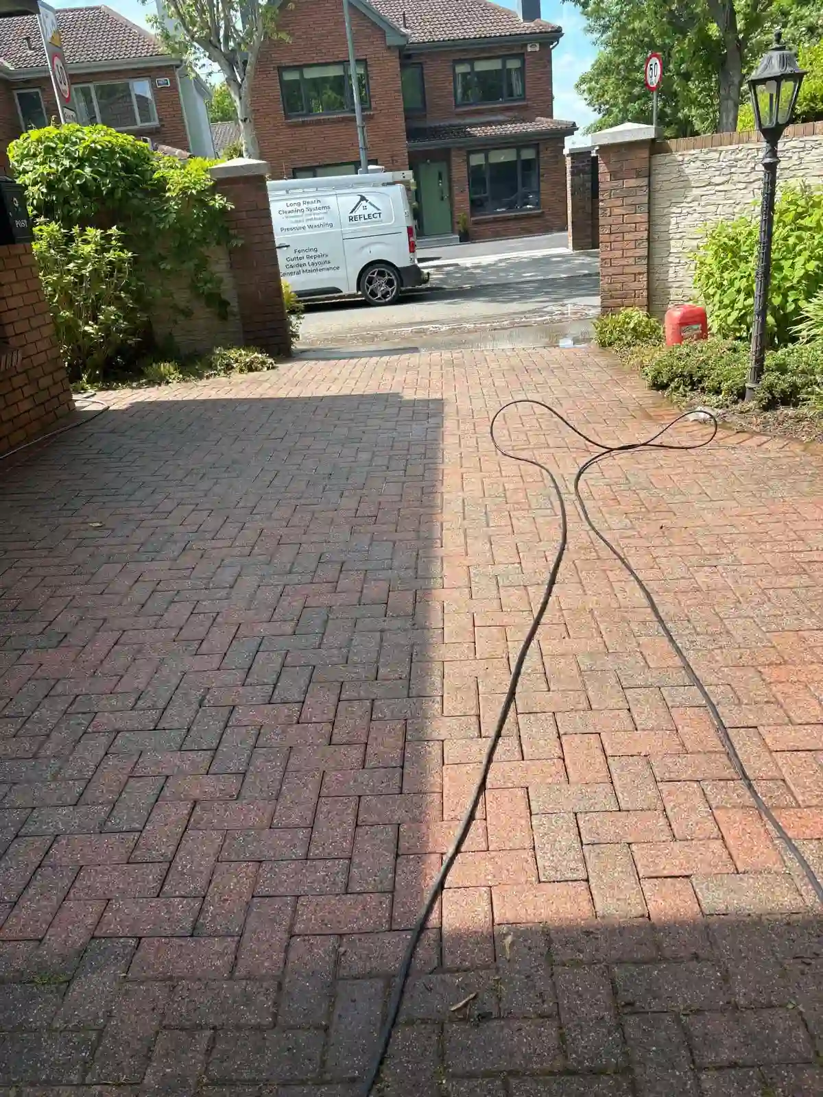 Completed driveway cleaning on a hard exterior surface